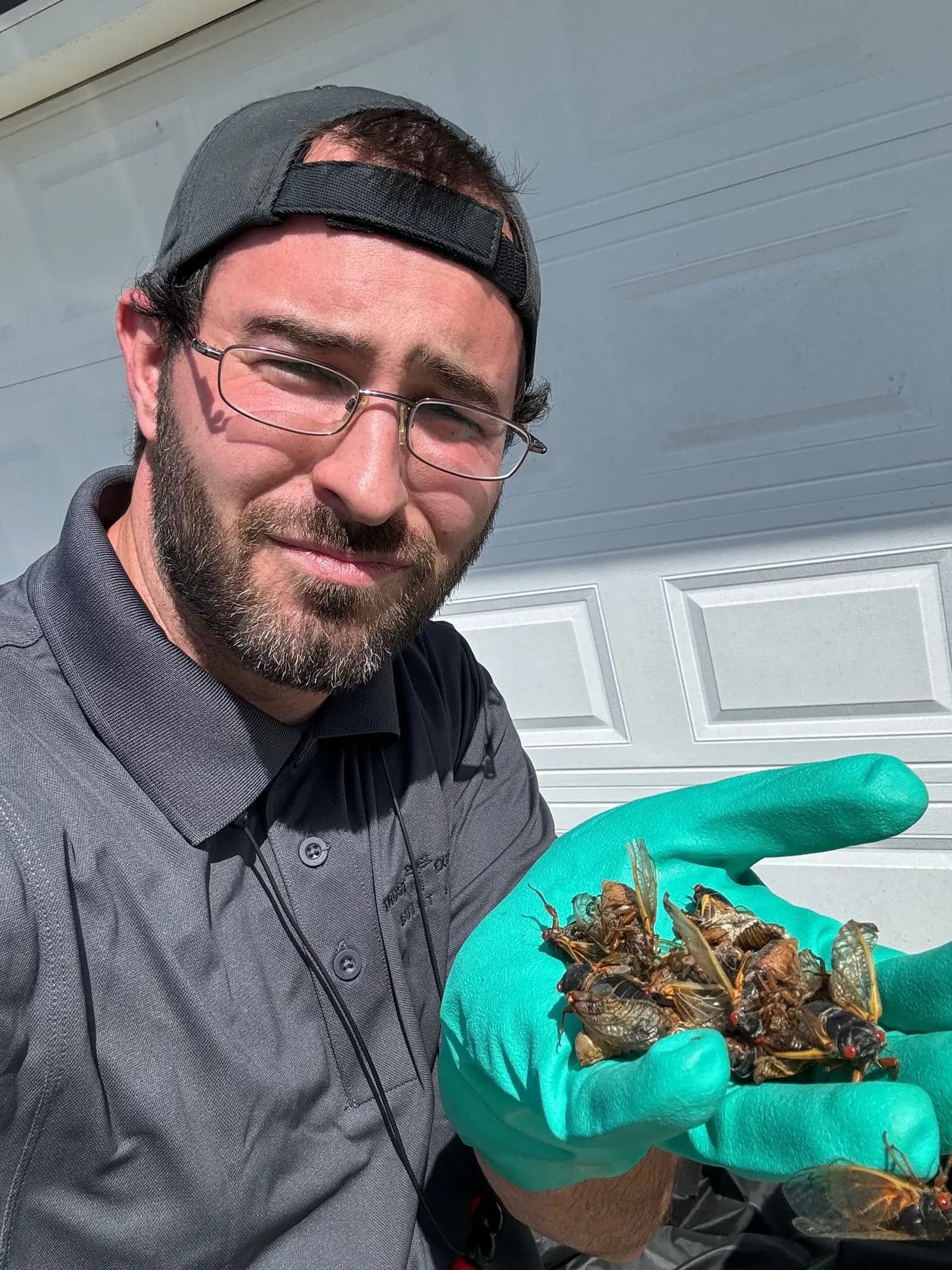 Owner Jerry Weaver holding pests removed from a customer's home